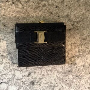 Salvatore Ferragamo bifold wallet in classic black. kisslock closure